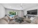 A spacious living room with a comfortable sofa, a ceiling fan and access to the outdoor pool area at 4341 W Pelotazo Way, San Tan Valley, AZ 85144