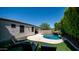 A stunning backyard pool with a rock waterfall and lush landscaping at 4341 W Pelotazo Way, San Tan Valley, AZ 85144