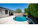 An inviting backyard pool with a rock waterfall feature and travertine decking at 4341 W Pelotazo Way, San Tan Valley, AZ 85144