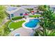 Aerial view of a backyard featuring a pool, patio, fire pit, solar panels, and professional landscaping at 6731 S 37Th Dr, Phoenix, AZ 85041