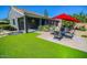 Landscaped backyard featuring an outdoor patio with seating, an artificial lawn and desert foliage at 6731 S 37Th Dr, Phoenix, AZ 85041