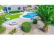 A backyard with a pool, fire pit, outdoor seating under umbrellas, and well-maintained landscaping at 6731 S 37Th Dr, Phoenix, AZ 85041