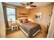Bedroom featuring a queen bed, side table with lamp, and window at 6731 S 37Th Dr, Phoenix, AZ 85041