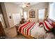 Bright bedroom featuring a wooden bed frame, vaulted ceilings, and a closet at 6731 S 37Th Dr, Phoenix, AZ 85041