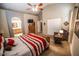 Cozy bedroom with a decorative ceiling fan, arched entry to bath and walk-in closet with double doors at 6731 S 37Th Dr, Phoenix, AZ 85041