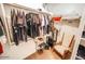 Walk-in closet with an organized clothing rack and an assortment of shoes, a chair and blankets on the shelf at 6731 S 37Th Dr, Phoenix, AZ 85041
