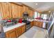 Modern kitchen with wood cabinets, stainless steel appliances and a view of the backyard at 6731 S 37Th Dr, Phoenix, AZ 85041