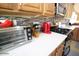Close-up of the well-equipped kitchen countertop with stainless steel appliances and wooden cabinets at 6731 S 37Th Dr, Phoenix, AZ 85041
