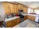 The kitchen boasts stainless steel appliances, wood cabinets, and generous countertop space at 6731 S 37Th Dr, Phoenix, AZ 85041