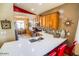 A gourmet kitchen island with a stainless sink, red bar stools, and a view to the dining room at 6731 S 37Th Dr, Phoenix, AZ 85041