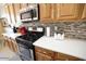 This well-equipped kitchen features modern stainless steel appliances and plenty of wood cabinets at 6731 S 37Th Dr, Phoenix, AZ 85041