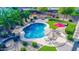 Backyard oasis with a sparkling pool, patio seating, lush landscaping and a charming fire pit for outdoor entertaining at 6731 S 37Th Dr, Phoenix, AZ 85041