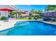 Inviting backyard pool surrounded by lush landscaping and patio furniture at 6731 S 37Th Dr, Phoenix, AZ 85041