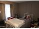 Bedroom with a bed, lace curtains, and decor at 6960 W Peoria Ave # 156, Peoria, AZ 85345