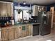 Functional kitchen with stainless steel appliances, wood cabinets, and plenty of counter space at 6960 W Peoria Ave # 156, Peoria, AZ 85345