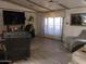 Spacious living room with wood-look flooring, bright windows, and neutral walls at 6960 W Peoria Ave # 156, Peoria, AZ 85345