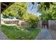 This backyard is fenced and includes green grass and a gate on the right at 717 W Manhatton Dr, Tempe, AZ 85282