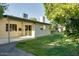 This is the backyard of the house with a covered patio and green grass at 717 W Manhatton Dr, Tempe, AZ 85282