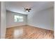 Spacious bedroom with hardwood floors, a ceiling fan, and a bright window at 717 W Manhatton Dr, Tempe, AZ 85282