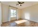 Bright bedroom with wood flooring, a ceiling fan, and large windows at 717 W Manhatton Dr, Tempe, AZ 85282
