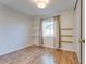 Comfortable bedroom with wood flooring, stylish shelving, and a bright window at 717 W Manhatton Dr, Tempe, AZ 85282