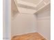 Walk-in closet with wood flooring, built-in shelving, and ample storage space at 717 W Manhatton Dr, Tempe, AZ 85282