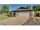 Brick home featuring a spacious two-car garage and an ample driveway for additional parking at 717 W Manhatton Dr, Tempe, AZ 85282