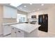 Bright, updated kitchen featuring white cabinets, quartz countertops, and stainless steel appliances at 717 W Manhatton Dr, Tempe, AZ 85282