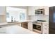 Modern kitchen boasts white cabinetry, stainless steel appliances, and stylish subway tile backsplash at 717 W Manhatton Dr, Tempe, AZ 85282