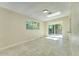 Open living room with tile flooring, skylight, and sliding glass doors leading to the backyard at 717 W Manhatton Dr, Tempe, AZ 85282