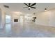 Spacious living room features tile flooring, a cozy fireplace, and seamless flow into the kitchen at 717 W Manhatton Dr, Tempe, AZ 85282