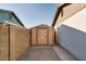 Small storage shed between two houses with a brick and concrete path at 717 W Manhatton Dr, Tempe, AZ 85282