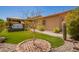 Well-maintained backyard with artificial turf, desert landscaping, a hot tub under a pergola, and a view of the home at 7413 W Southgate Ave, Phoenix, AZ 85043