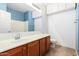 This bathroom features a sink with a mirror, cabinets for storage, and tile flooring at 7413 W Southgate Ave, Phoenix, AZ 85043