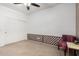 A Minimal bedroom featuring a closet, decorative chair, neutral colored walls, and carpet floors at 7413 W Southgate Ave, Phoenix, AZ 85043