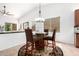 Bright breakfast nook featuring barrel table, pendant lighting, and backyard view at 7413 W Southgate Ave, Phoenix, AZ 85043