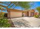 Inviting exterior featuring a three-car garage and well-maintained desert landscaping at 7413 W Southgate Ave, Phoenix, AZ 85043