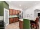 Gourmet kitchen featuring granite countertops, stainless steel appliances, and breakfast bar at 7413 W Southgate Ave, Phoenix, AZ 85043