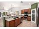 Open kitchen with granite countertops, stainless appliances, breakfast bar, and ample cabinetry at 7413 W Southgate Ave, Phoenix, AZ 85043