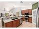 Bright open kitchen featuring granite countertops, stainless appliances, breakfast bar, and bar seating at 7413 W Southgate Ave, Phoenix, AZ 85043