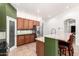 Updated kitchen features granite countertops, stainless steel appliances, and a breakfast bar at 7413 W Southgate Ave, Phoenix, AZ 85043