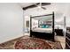 Spacious primary bedroom featuring a grand four-poster bed and accent rug at 7413 W Southgate Ave, Phoenix, AZ 85043