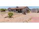Backyard with a patio, metal art, desert landscaping, and small shed at 7730 E Culver St, Mesa, AZ 85207