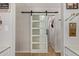 Stylish white barn door with five panes of glass, adding modern flair to the home's interior design at 7730 E Culver St, Mesa, AZ 85207