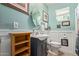 Bathroom boasts a pedestal sink, oval mirror, and wood-look flooring at 7730 E Culver St, Mesa, AZ 85207