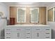 Bathroom vanity with double sinks, framed mirrors, and ample storage space in white cabinets at 7730 E Culver St, Mesa, AZ 85207