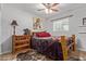 Rustic bedroom features a log bed, ceiling fan, zebra painting, and wooden dresser at 7730 E Culver St, Mesa, AZ 85207
