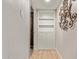 Hallway with built-in storage including shelves and cabinets, offering convenient organizational space at 7730 E Culver St, Mesa, AZ 85207