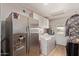 Functional laundry room with washer, dryer, and built-in cabinetry at 7730 E Culver St, Mesa, AZ 85207