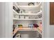 Walk-in pantry with wood shelving offering ample storage space at 7730 E Culver St, Mesa, AZ 85207